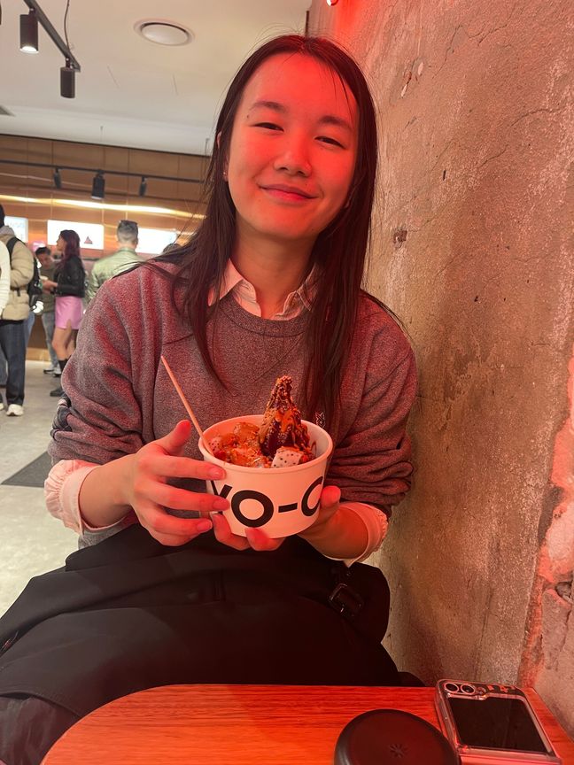 Wing holding a bowl of Yo-Chi frozen yoghurt.